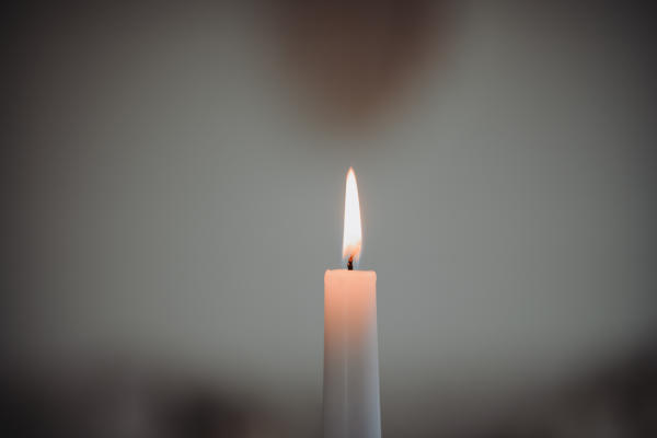 Eine brennende Kerze in Nahaufnahme. 
